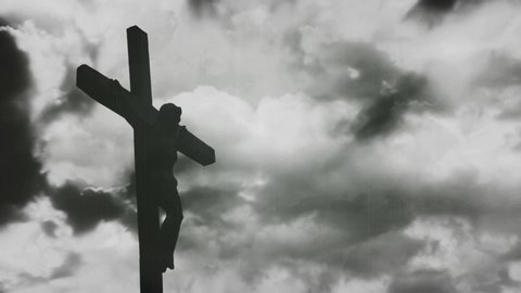 Jesus Christ crucified at Golgotha hill outside ancient Jerusalem. The Crucifixion of Christ with Stormy clouds time lapse. Vintage film look, 4k video