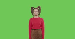 Friendly girl waving hand smiling greeting welcoming over green screen background. Cheerful pretty woman smiling on chroma key. 4k raw video footage slow motion