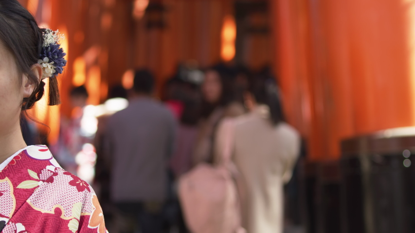 Footage of girl in traditional Japanese Kimono at Fushimi Inari Taisha. Kyoto. Japanese Culture.