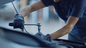 Slow Motion Close Up Footage of a Female Mechanic Working on a Car in a Car Service. Empowering Woman Makes an Usual Car Maintenance. She's Using a Ratchet. Modern Clean Workshop. - Powered by Shutterstock - Get 15% off with code: PIKWIZARD15