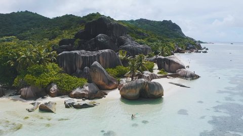 Aerial drone view on the beautiful white sand rocky beach in the seychelles, La digue silver bay 