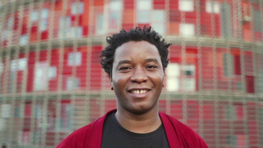 Smiling mature man wearing red coat and looking at camera