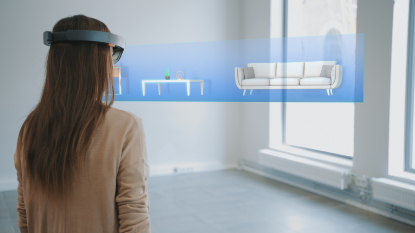 Decorating Apartment: Pretty Woman Wearing Mixed Reality Headset Uses Augmented Reality Interior Design Software to Choose Type and Color of the Furniture for Living Room. 3D Render Royalty-Free Stock Footage #1047633145