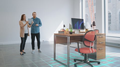 In Empty New Office: Female Interior Designer and Male Office Architect Talk, Use Augmented Reality Software on Digital Tablet Computer to Choose, Move and Manipulate 3D Furniture. VFX Special Effects