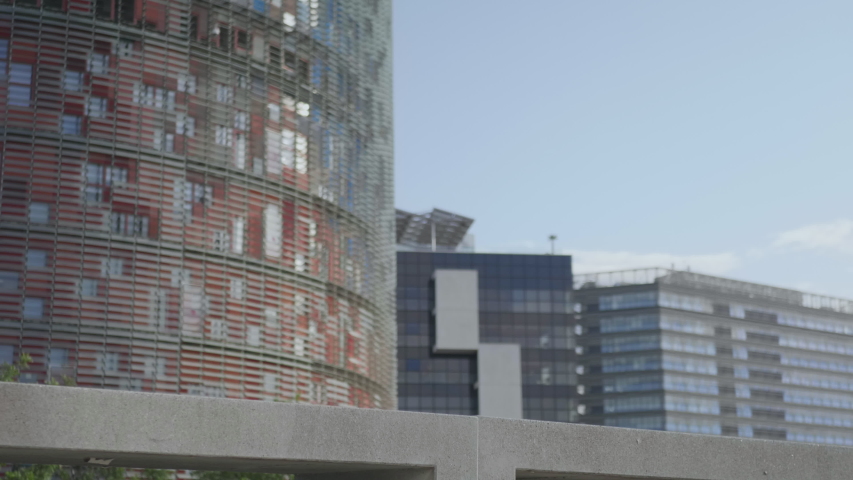 Worried businessman sitting on bench at city street. Disappointed male entrepreneur thinking about work on street. Upset business man taking break outside office in Barcelona.