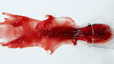 Super Slow Motion Top Shot of Falling Glass with Red Wine on White Cloth at 1000fps.