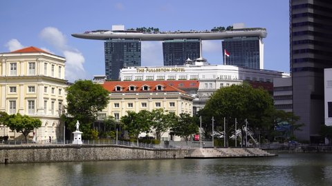 Singapore city, Singapore - february 28, 2020 : Singapore River Embankment in the city center and view of the Marina Bay Sands Hotel at sunny day