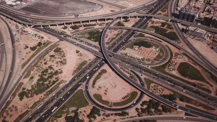 Tilting aerial view of busy highway during rush hour traffic in Riyadh, infrastructure transportation economy Saudi Arabia Royalty-Free Stock Footage #1047638953
