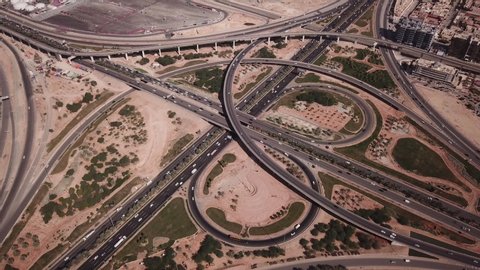 Tilting aerial view of busy highway during rush hour traffic in Riyadh, infrastructure transportation economy Saudi Arabia