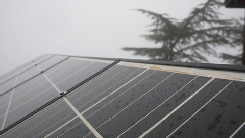 Solar battery in cloudy rainy weather on top of a mountain.