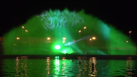RIYADH, SAUDI ARABIA – DECEMBER 2019: National flag of Saudi Arabia depicted in water fountain show at Riyadh season night festival