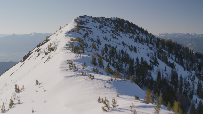 Snow-covered peaks, steep cliffs and rugged terrain in the Gallatin mountains, Montana