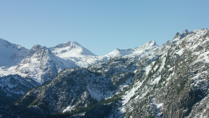 The snowcapped peaks, steep cliffs and dense forests of the Absaroka mountain Range near Yellowstone National Park
