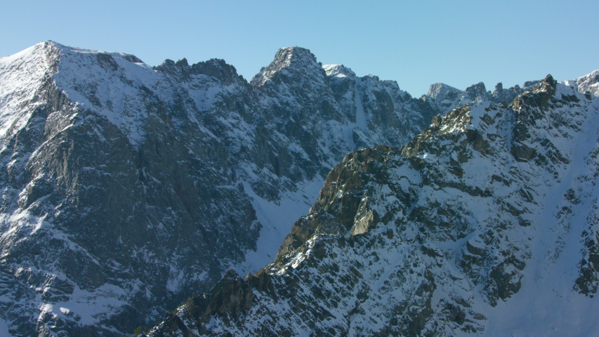 The snowcapped peaks, steep cliffs and dense forests of the Absaroka mountain Range near Yellowstone National Park