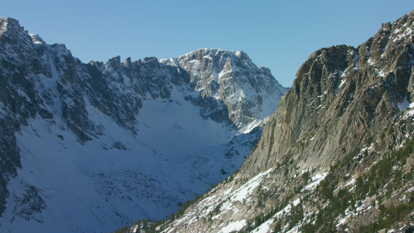 The snowcapped peaks, steep cliffs and dense forests of the Absaroka mountain Range near Yellowstone National Park