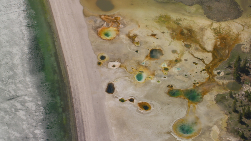 The West Thumb Geyser Basin features dramatic, colorful geothermal features, and sits next to a frozen Yellowstone Lake, in Yellowstone National Park