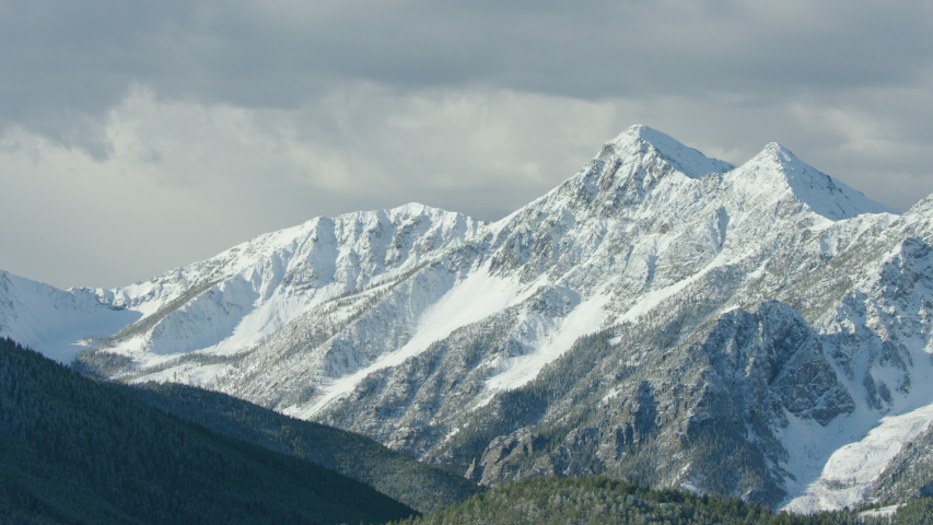 The snowcapped peaks, steep cliffs and dense forests of the Absaroka mountain Range near Yellowstone National Park