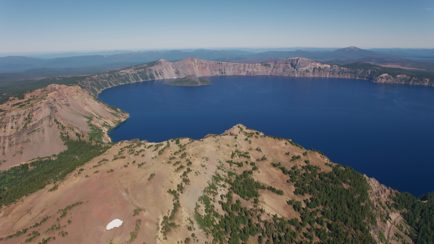 Aerial view of Crater Lake in Central Oregon, USA. Shot from helicopter with cineflex gimal and RED 8K camera.