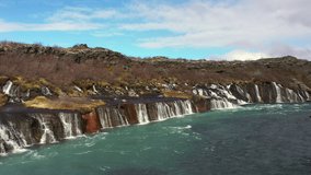 Hraunfossar waterfall located near Husafell, Iceland.
Video made in spring in April using a drone. Beautiful color water, brown vegetation and blue sky with clouds.