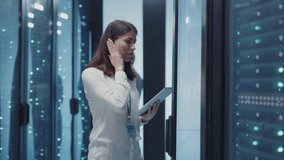 IT woman support operator coworking with male technician conducting full lifecycle data analysis on network server cabinet in high tech data center. Business teamwork. - Powered by Shutterstock - Get 15% off with code: PIKWIZARD15