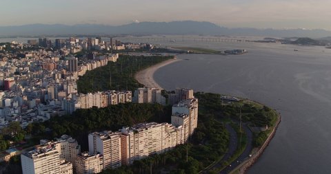 Flying above Flamengo Beach and cityscape of Rio de Janeiro towards downtown buildings at sunrise, Brazil 