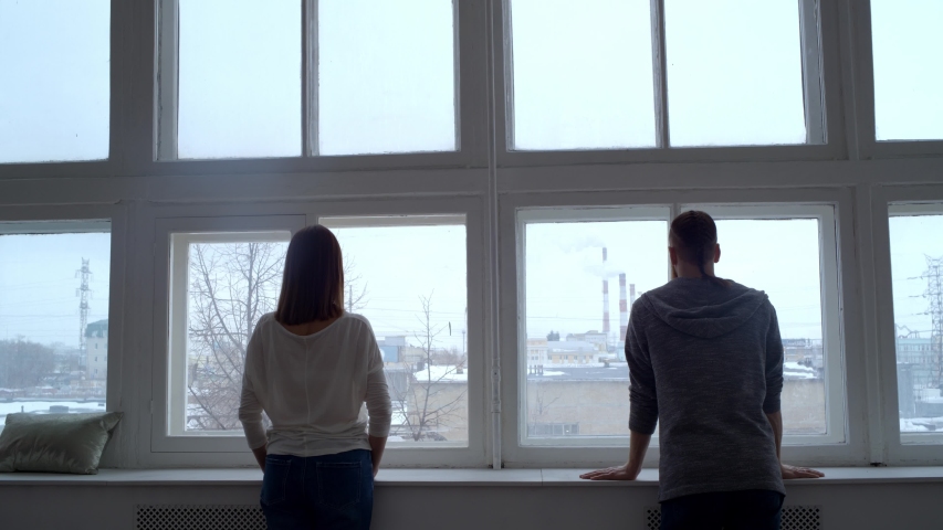 Portrait of a man and woman on the background of a window.