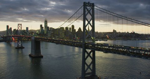Aerial view of the San Francisco Oakland Bay Bridge. California, USA. With traffic. Financial District skyline with its well known skyscrapers. Shot on Red weapon 8K.