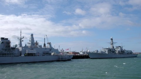 PORTSMOUTH/UNITED KINGDOM - FEBRUARY 4TH 2020: Camera tracks past Royal Navy frigates HMS Westminster and HMS Kent docked in Portsmouth. Taken from moving boat.