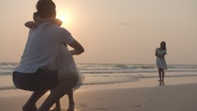 Happy family father and daugther hug and kiss each together on beach and sea with sun flare in evening. Family, Freedom, Relationship, embrace and Travel concept. Positive emotion and feeling warm. - Powered by Shutterstock - Get 15% off with code: PIKWIZARD15