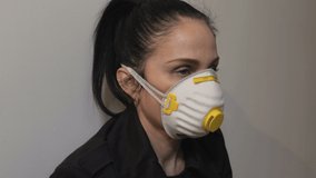 Woman in Respiratory face mask at indoor with Headache