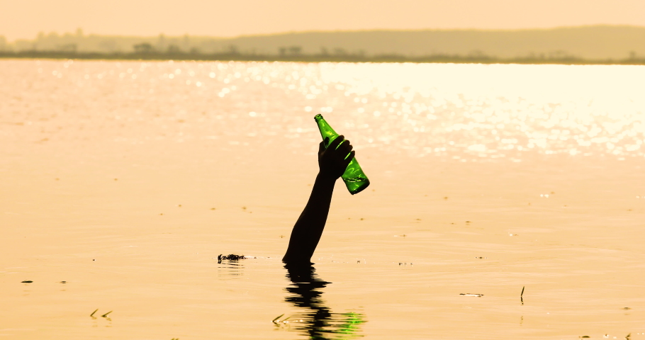 Hand rising out of the lake with water bottles, Raise your hand out of the water with garbage.Garbage collection in the river,Environment concept