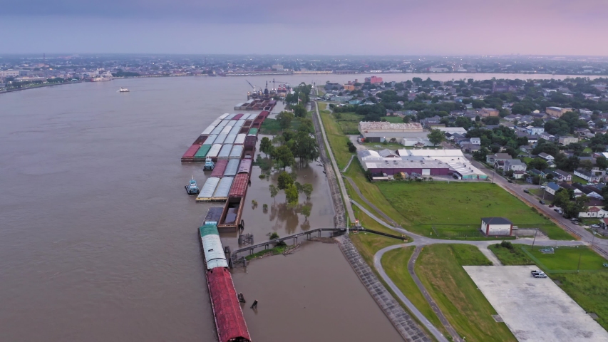 Aerial: Mississippi River waterfront and barges, New Orleans, Louisiana, USA 