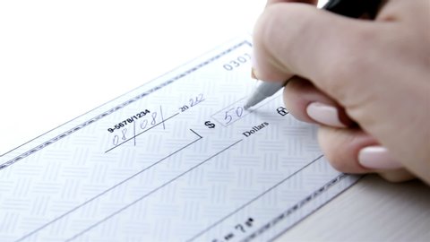 Business woman prepare writing a check. Paycheck concept. Payment by cheque