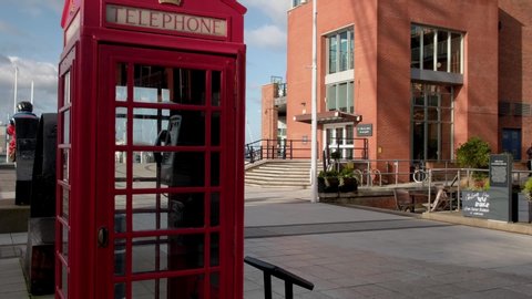 PORTSMOUTH/ENGLAND - FEBRUARY 4TH 2020: Tilt up Spinnaker Tower from traditional red telephone box. Gunwharf Quays, Portsmouth