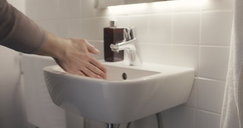 Woman washing hands the best way rinse with water rub with soap dry with towel virus outbreak protection