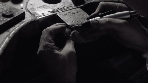 Jeweler crafting a diamond ring jewel with his tools medium shot
