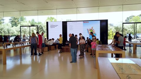 Cupertino, California, USA - August 2019: Apple Store in Cupertino with people examining Apple products, Apple Headquarters infinite loop