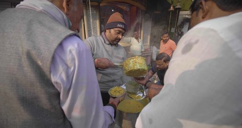 JANUARY INDIA 2020: Indian Social worker feeding poor people by giving away fresh cooked food in Varanasi, Uttar Pradesh, India