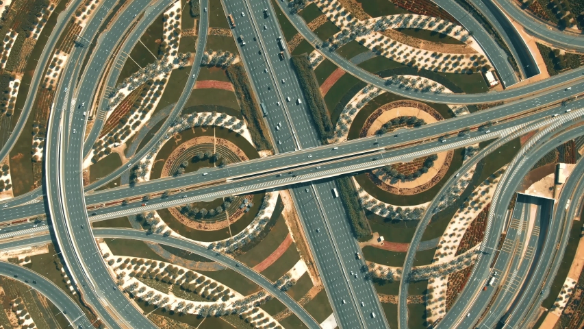 Aerial top down view of a big highway interchange traffic in Dubai, UAE Royalty-Free Stock Footage #1047784531