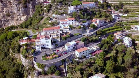 Italian Amalfi coastline road turn with terraces near Positano, Aerial drone top view lowering shot