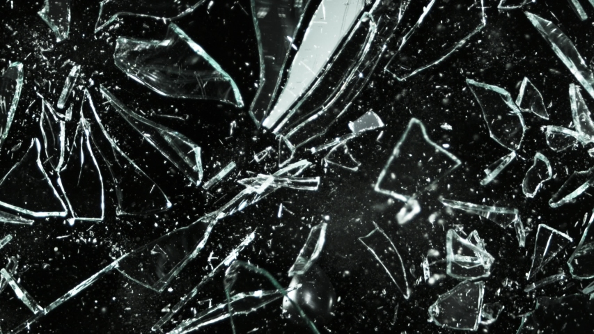 Super slow motion of shattered glass on black background. Filmed on high speed cinema camera, 1000 fps.