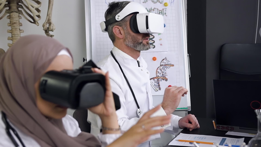 Side view of doctors or scientists which learning medicine in simulation with the Virtual Reality glasses. Slow motion - Powered by Shutterstock - Get 15% off with code: PIKWIZARD15