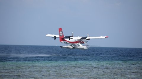 Fesdhu, Maldives - February 9 2020: Takeoff of a DHC-6 seaplane twin otter airplane of Trans Maldivian Airways in front of the reef at Fesdhu island