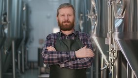 Portrait of businessman male brewer with beard looking at the camera and smiling while standing at a beer factory - Powered by Shutterstock - Get 15% off with code: PIKWIZARD15