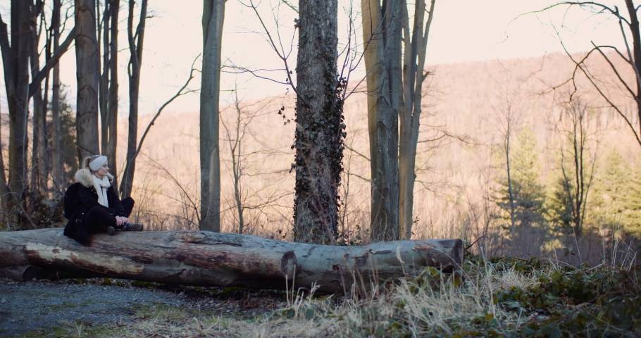 female tourist walking on a trail in mountains
