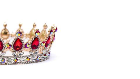 Gold crown with red jewel of precious stones panoramic view.