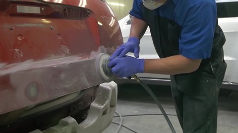 Mechanic Sanding Car for Body work at shop Auto Repair Collision