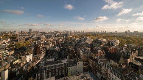 Timelapse of London skyline from an elevated view over Mayfair and West End with blue sky and a few clouds