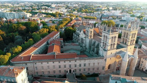Montpellier, France - July 2019: Aerial view of the city at sunrise. Occitanie Languedoc Roussillon. Panning around the iconic Saint-Pierre Cathedral.