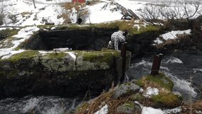 Girl drinks clean water from a mountain stream. HD Footage.